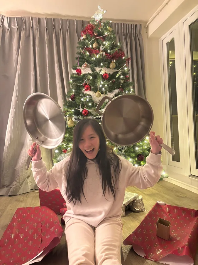 Ruth smiling with her new pans at Christmas